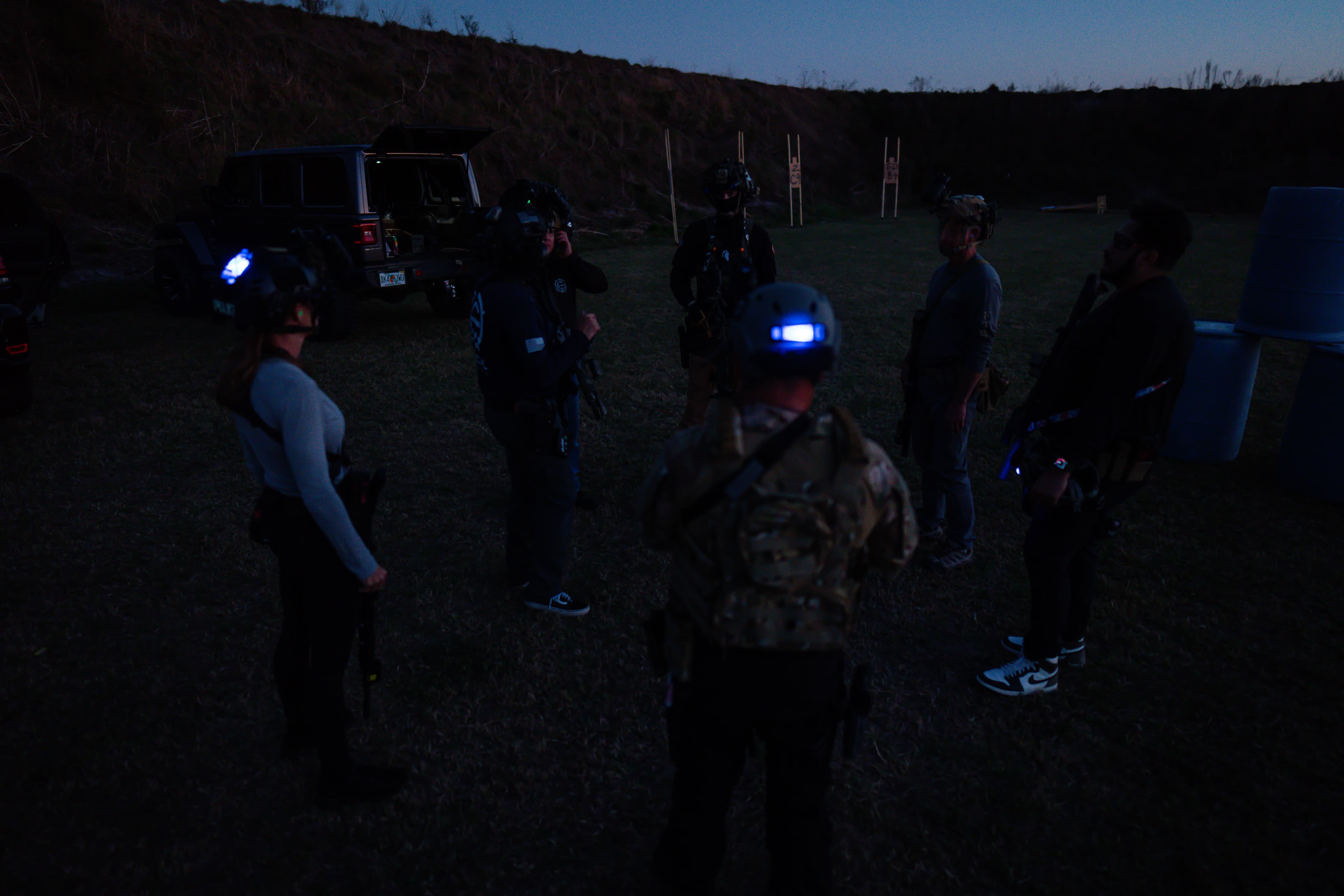 Night training briefing with team wearing illuminated headgear