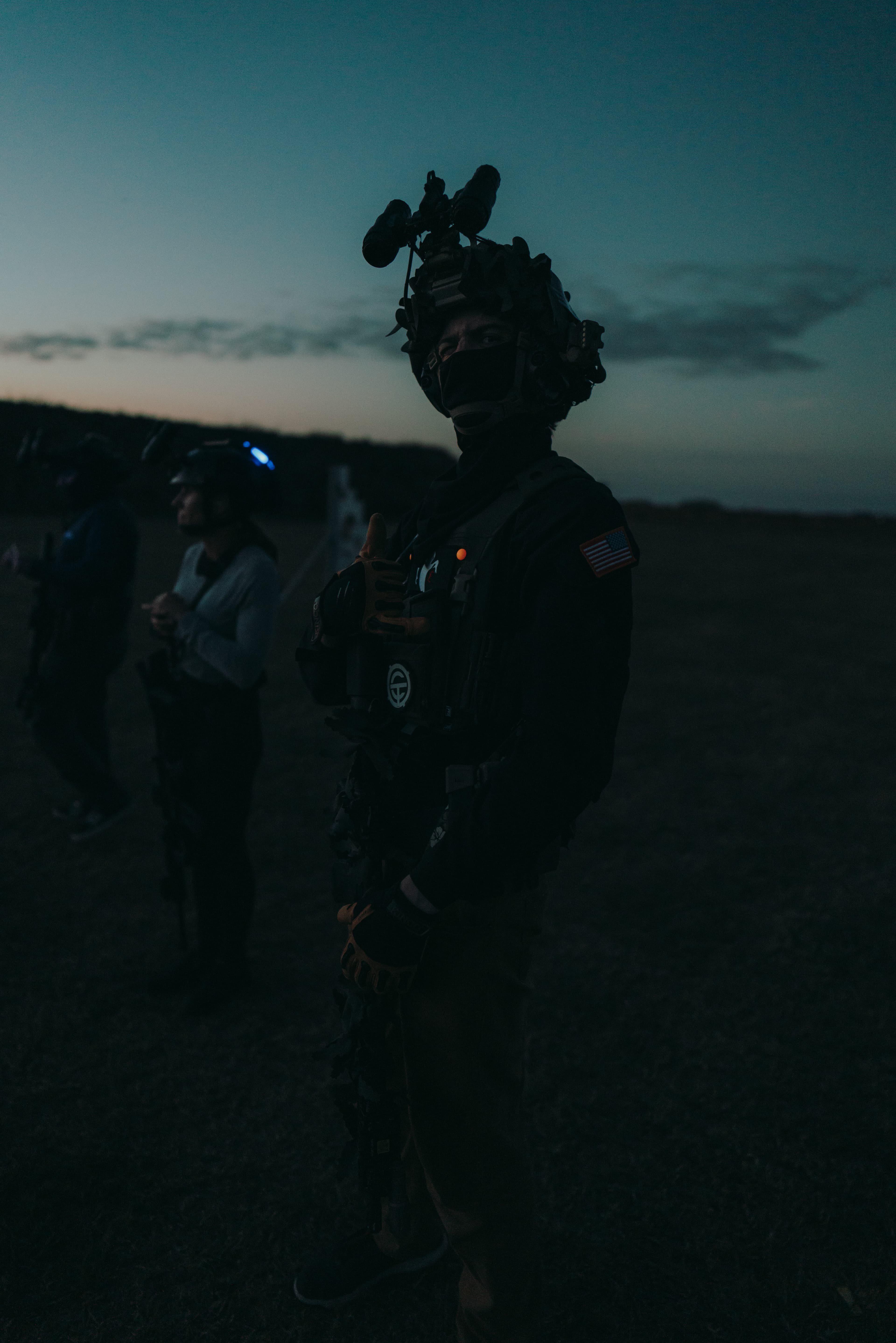 Operator in full NVG kit during night force-on-force training exercise