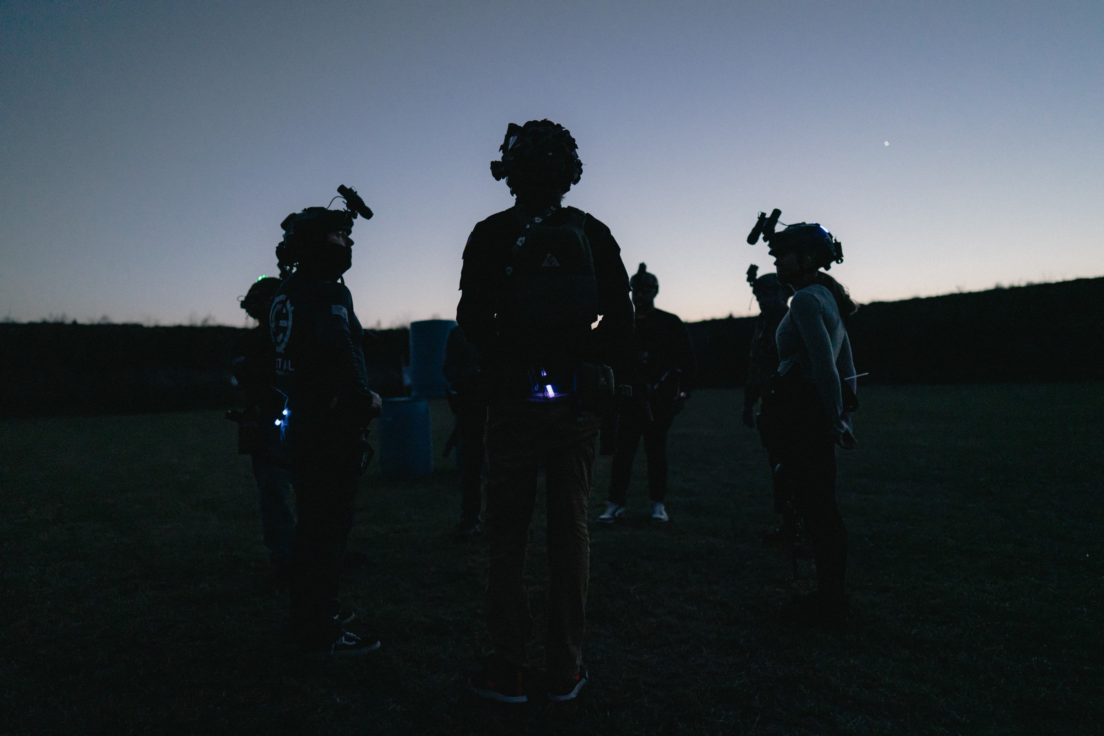 Tactical team silhouetted against twilight sky during night operations training